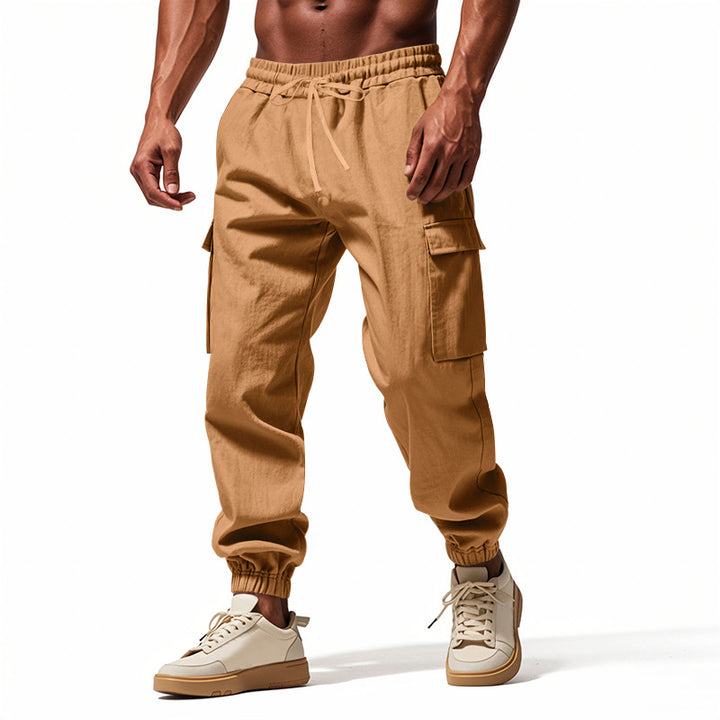 Men's tapered joggers in utilitarian style with elastic waistband, drawstring, and flap pockets StylebySassy
