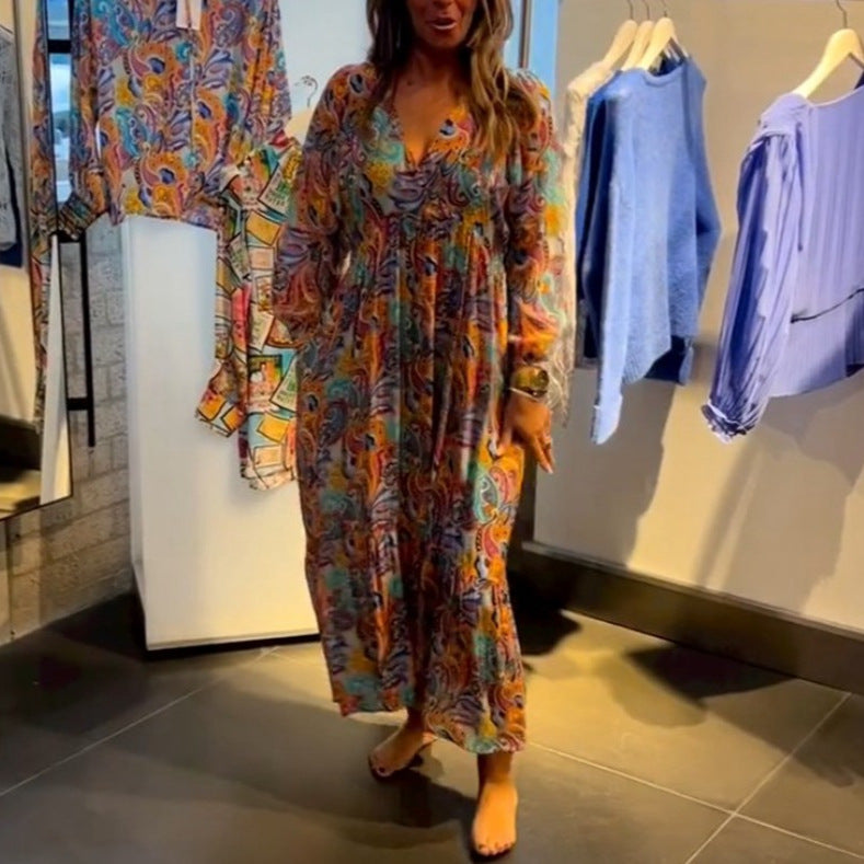 Women's tiered maxi dress in boho style with paisley print, V-neck, gathered empire waist and elastic cuffs StylebySassy