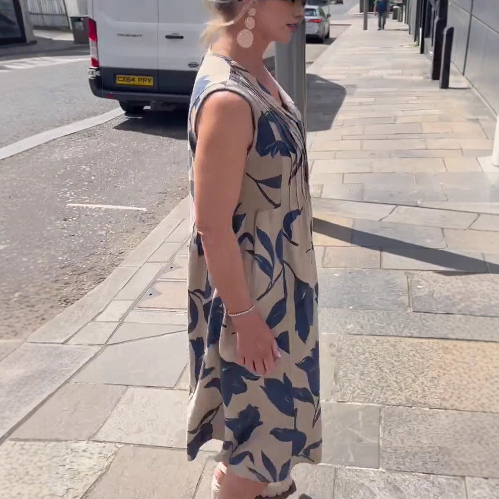 Women's sleeveless A-line midi dress with V-neck, bust pleats, button placket, and large floral print StylebySassy