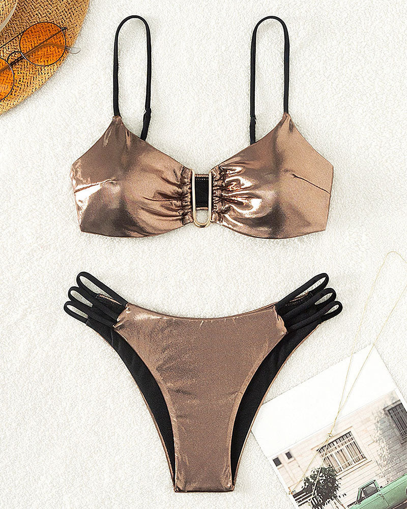 Women's bikini set with intricate lace-up look and golden accents StylebySassy