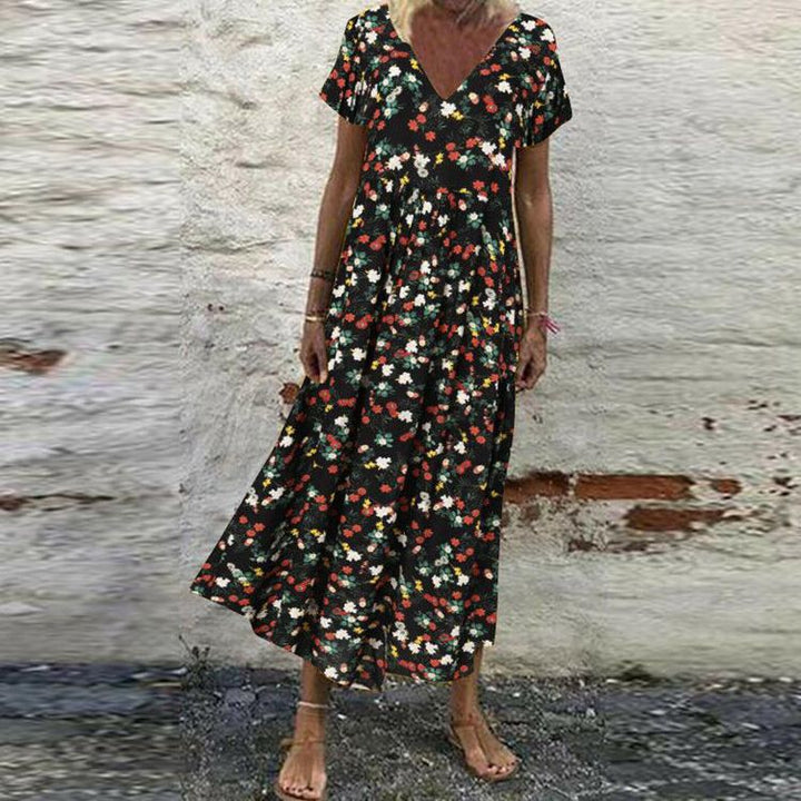 Women’s V-neck maxi dress with fine pleated skirt, empire bodice and short sleeves StylebySassy