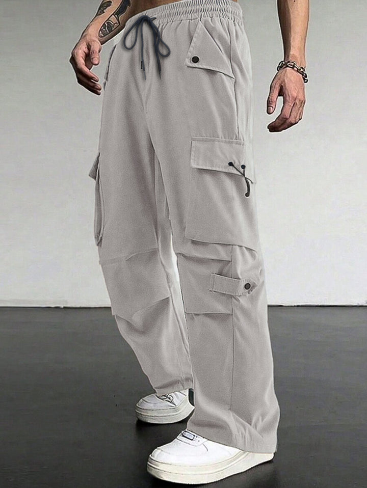Men's baggy cargo pants with utilitarian flap pockets, drawstring waistband, and reinforced seams StylebySassy