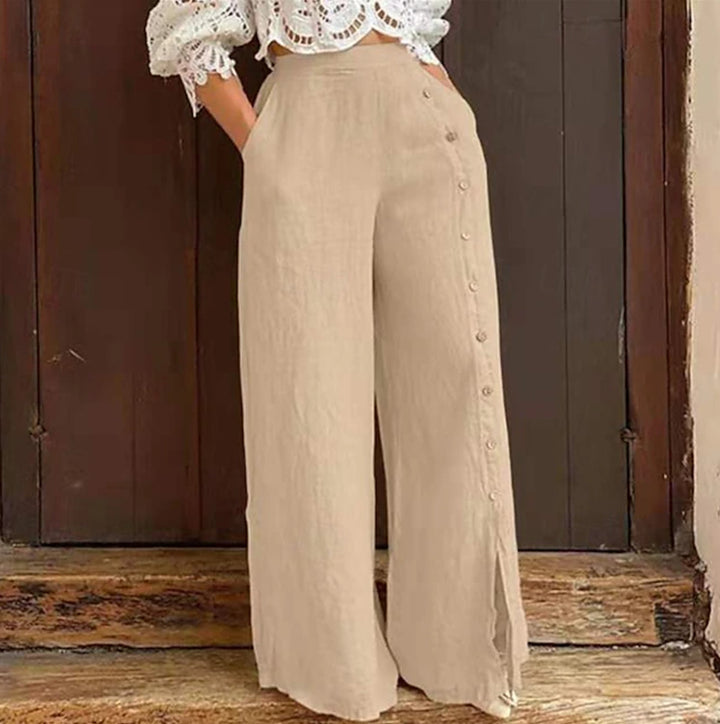 Women's high-waisted linen trousers with a side decorative button placket, side pockets, and wide leg cut StylebySassy