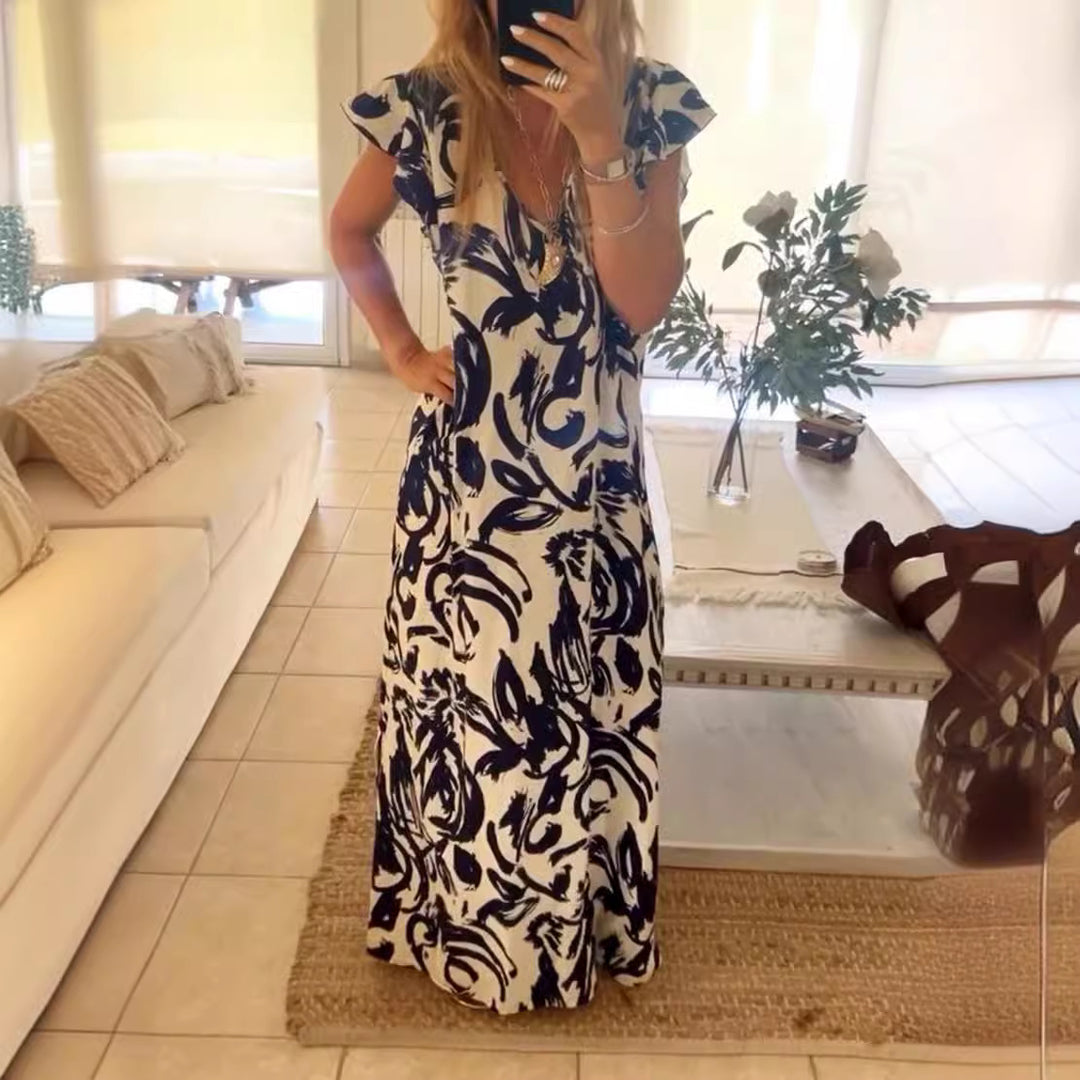 Women's flowing maxi dress with V-neck, flutter sleeves, and side leg slit StylebySassy
