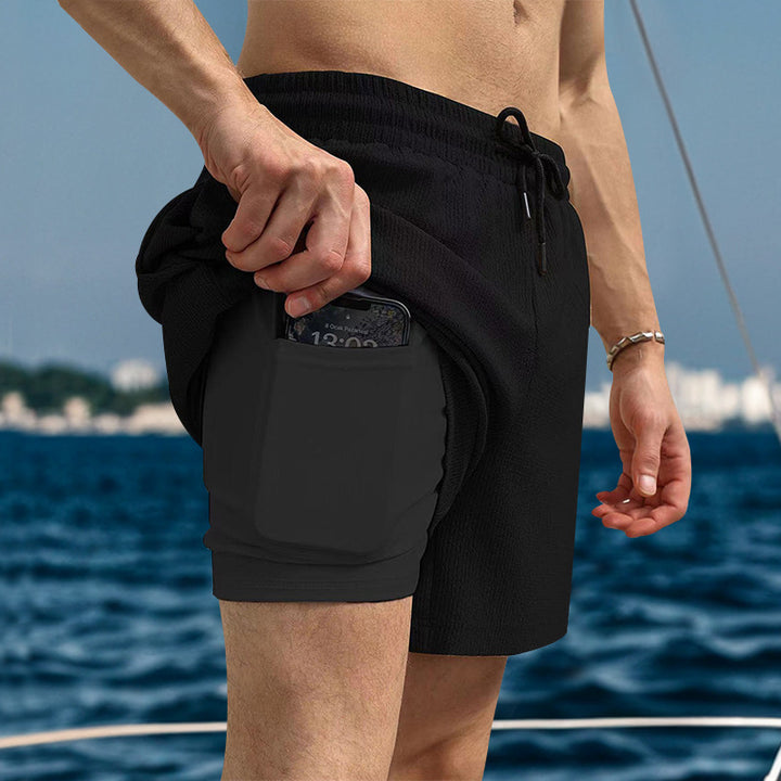 Men's two-layer swim shorts with integrated compression inner shorts and hidden cell phone pocket StylebySassy