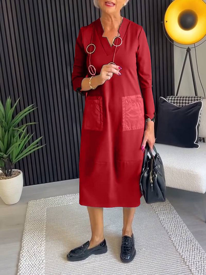 Women's knee-length, loosely falling dress with V-neck contrast pockets made of satin and three-quarter sleeves StylebySassy