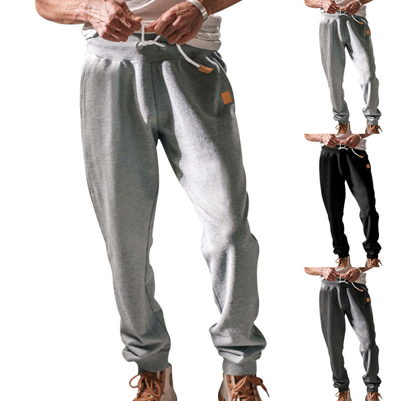 Men's tapered leisure pants made of sweat fabric with elastic waistband, drawstring, and ribbed cuffs StylebySassy