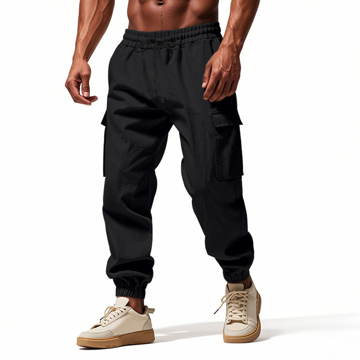 Men's tapered joggers in utilitarian style with elastic waistband, drawstring, and flap pockets StylebySassy
