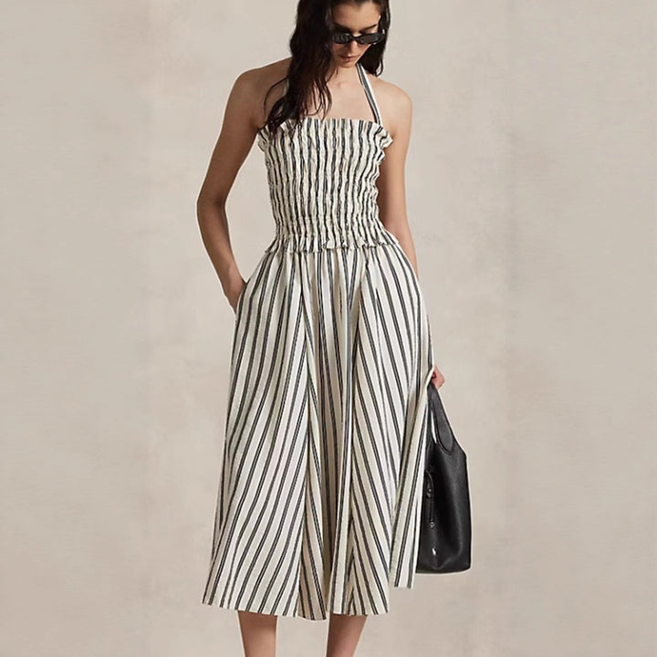 Women's midi dress with smocked bodice, adjustable halter strap, wide A-line skirt and side pockets StylebySassy