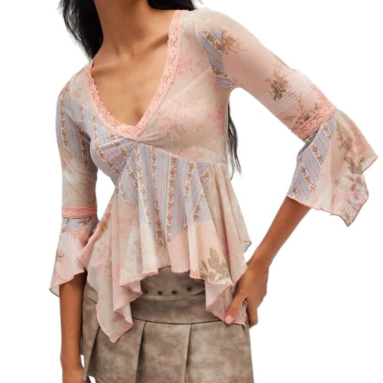 Ladies sheer mesh top with V-neck, lace trim, asymmetric ruffle hem, and bell sleeves StylebySassy