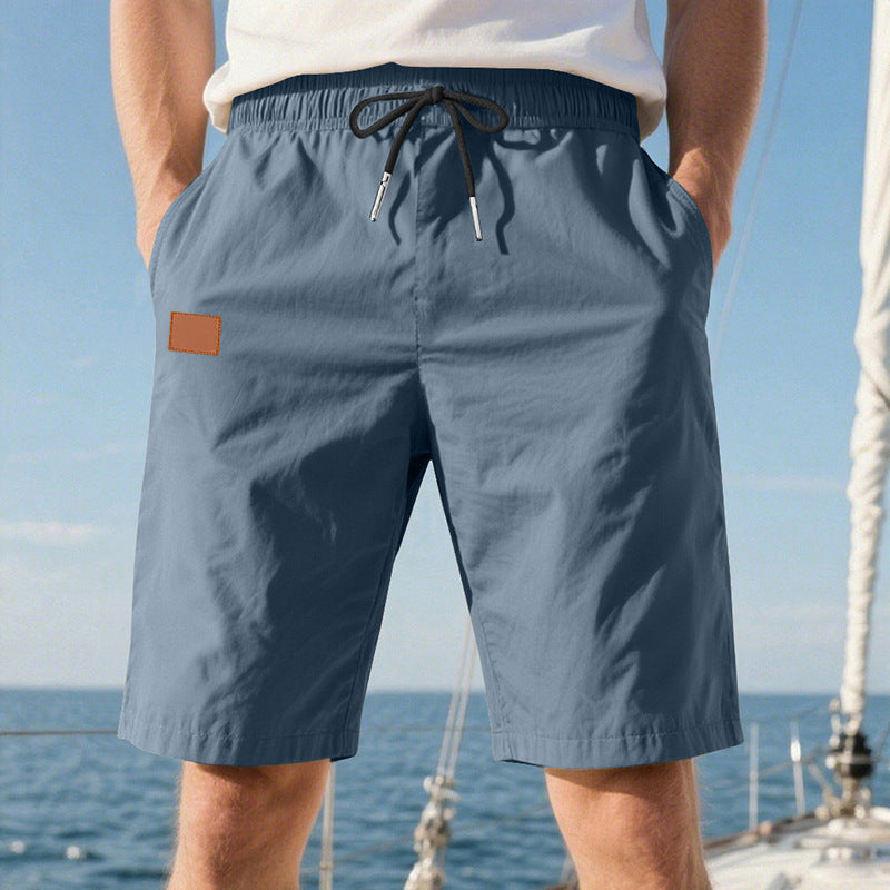 Men's quick-drying swim shorts in Bermuda cut with elastic waistband and drawstring StylebySassy