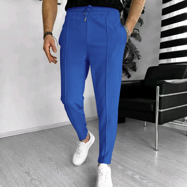 Men's tapered jogging chinos made of structured woven quality with elastic drawstring waistband and decorative crease StylebySassy