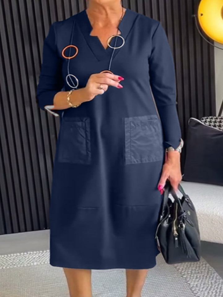 Women's knee-length, loosely falling dress with V-neck contrast pockets made of satin and three-quarter sleeves StylebySassy