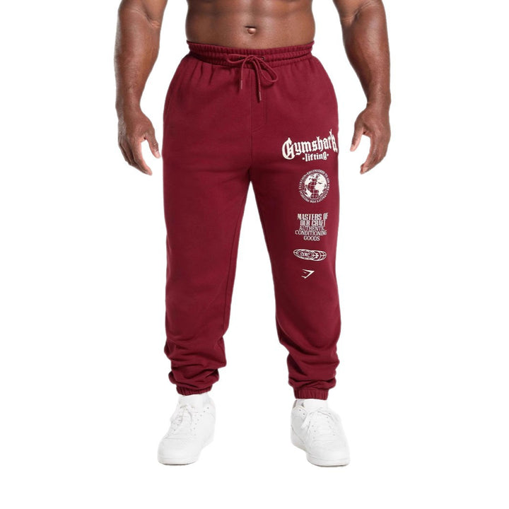 Men's tapered cotton fleece sweatpants with an elastic drawstring waistband, ribbed leg openings, and large logo print StylebySassy