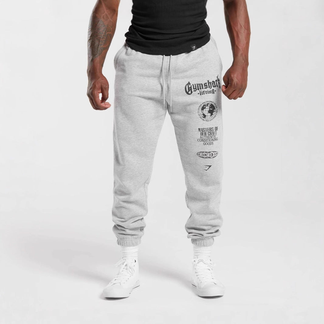 Men's tapered cotton fleece sweatpants with an elastic drawstring waistband, ribbed leg openings, and large logo print StylebySassy