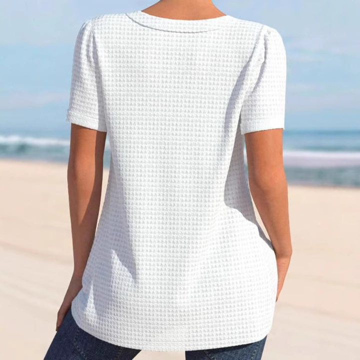 Women's finely structured V-neck top with decorative button placket and slightly flared silhouette StylebySassy