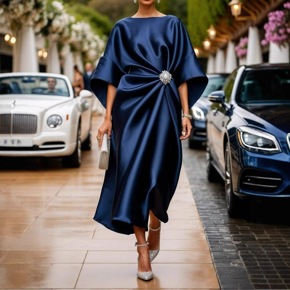 Women's elegant satin kaftan midi dress with kimono sleeves, side draping, and decorative brooch StylebySassy