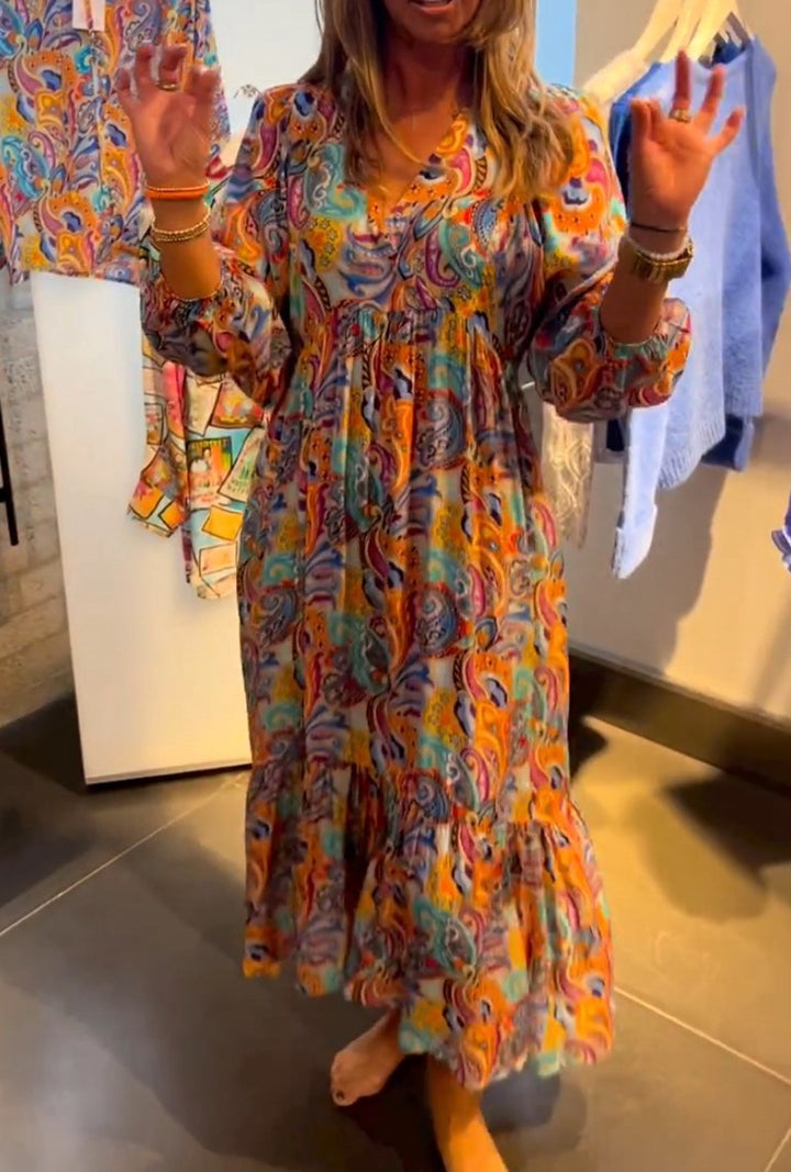 Women's tiered maxi dress in boho style with paisley print, V-neck, gathered empire waist and elastic cuffs StylebySassy
