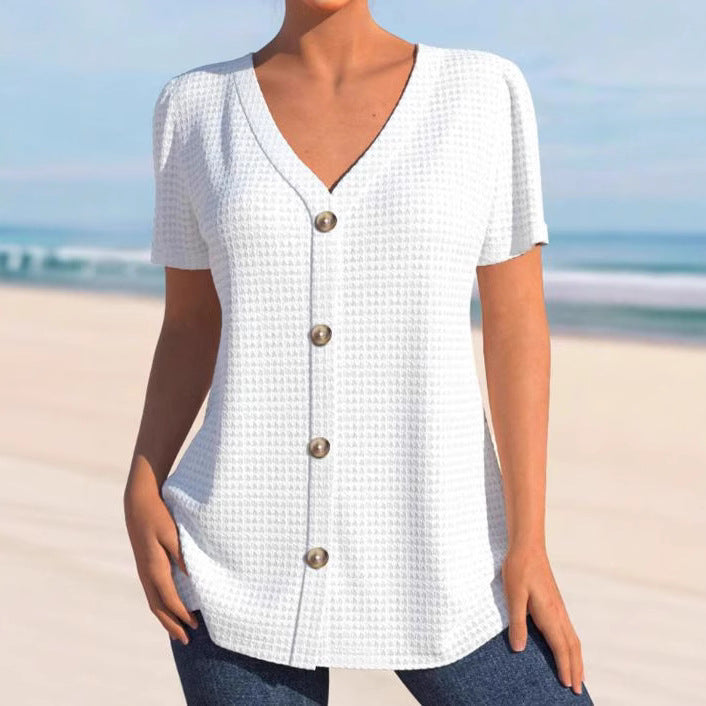 Women's finely structured V-neck top with decorative button placket and slightly flared silhouette StylebySassy