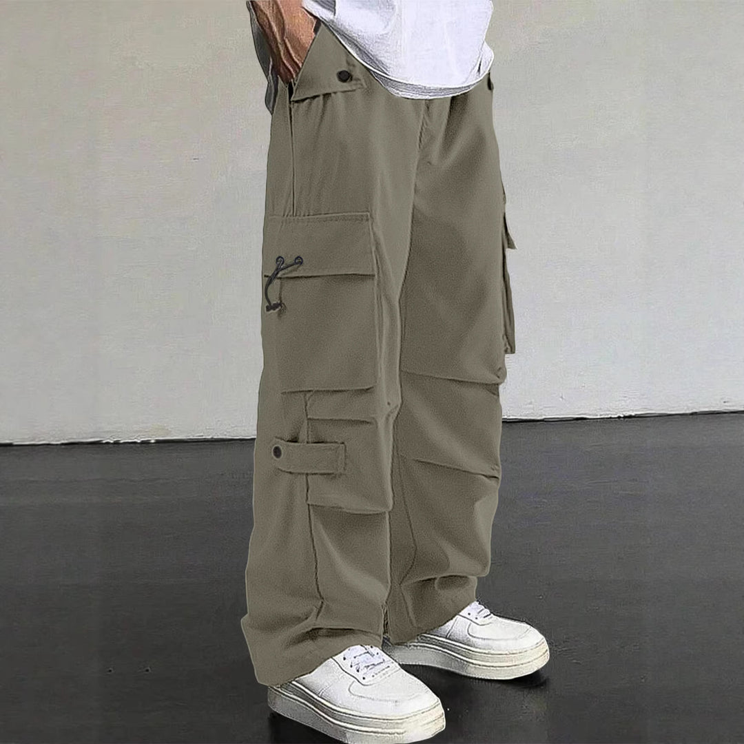 Men's baggy cargo pants with utilitarian flap pockets, drawstring waistband, and reinforced seams StylebySassy