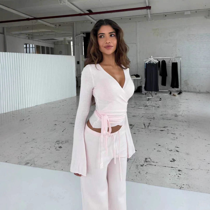 Women's knitted wrap top with tie belt and trumpet sleeves, as well as high-waisted wide-cut knitted pants StylebySassy