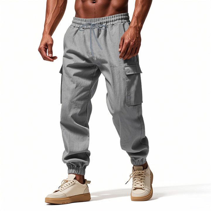 Men's tapered joggers in utilitarian style with elastic waistband, drawstring, and flap pockets StylebySassy