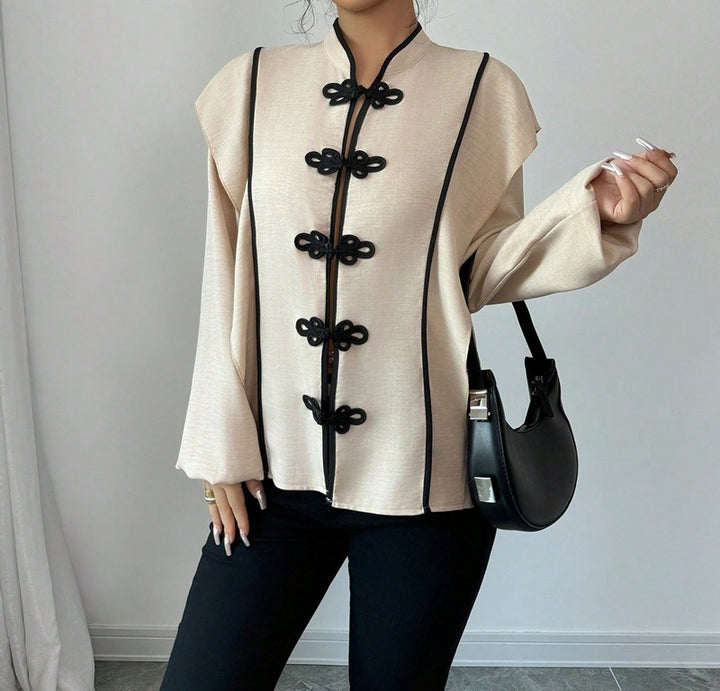 Women's stand-up collar blouse with decorative knot closures and decorative piping StylebySassy
