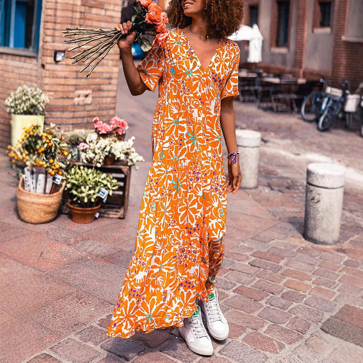 Women’s ankle-length V-neck maxi dress with graphic ethnic print, short sleeves and flared ruffle hem StylebySassy