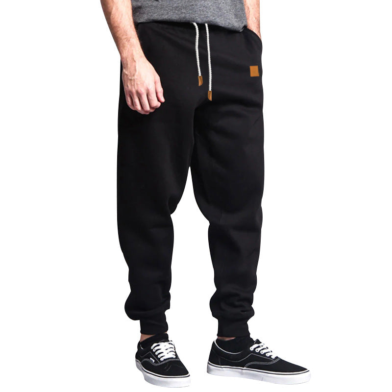 Men's tapered leisure pants made of sweat fabric with elastic waistband, drawstring, and ribbed cuffs StylebySassy