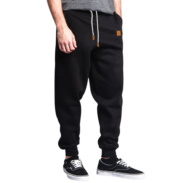 Men's tapered leisure pants made of sweat fabric with elastic waistband, drawstring, and ribbed cuffs StylebySassy