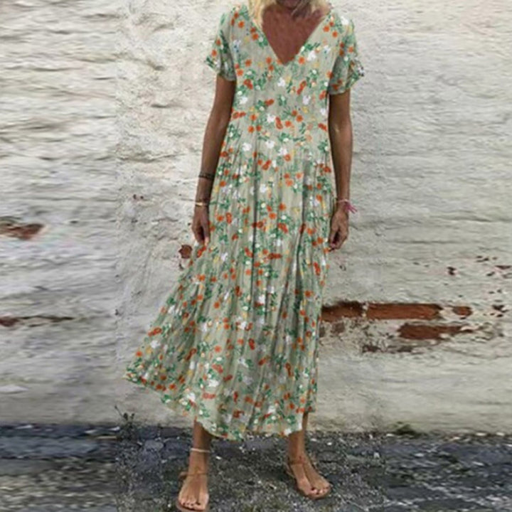 Women’s V-neck maxi dress with fine pleated skirt, empire bodice and short sleeves StylebySassy