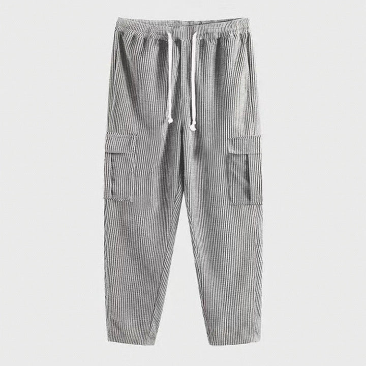Men's corduroy jogger-style pants with elastic drawstring waistband, flap cargo pockets, and tapered leg StylebySassy