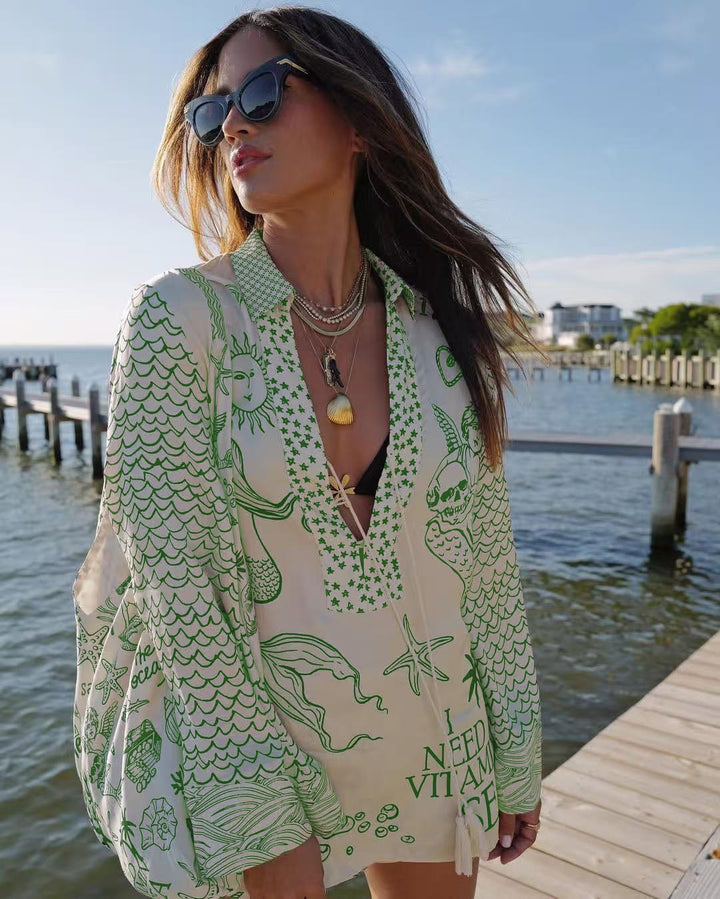 Ladies lightweight beach cover-up in tunic form with deep V-neck, tassel closure, and nautical ocean print StylebySassy