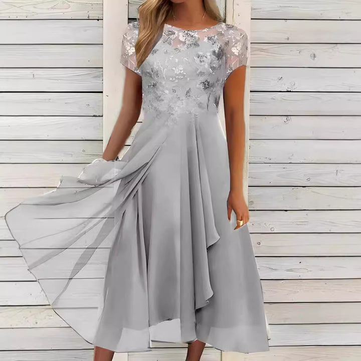 Women's flowing chiffon mid dress with floral embroidered top and asymmetrical tiered skirt StylebySassy