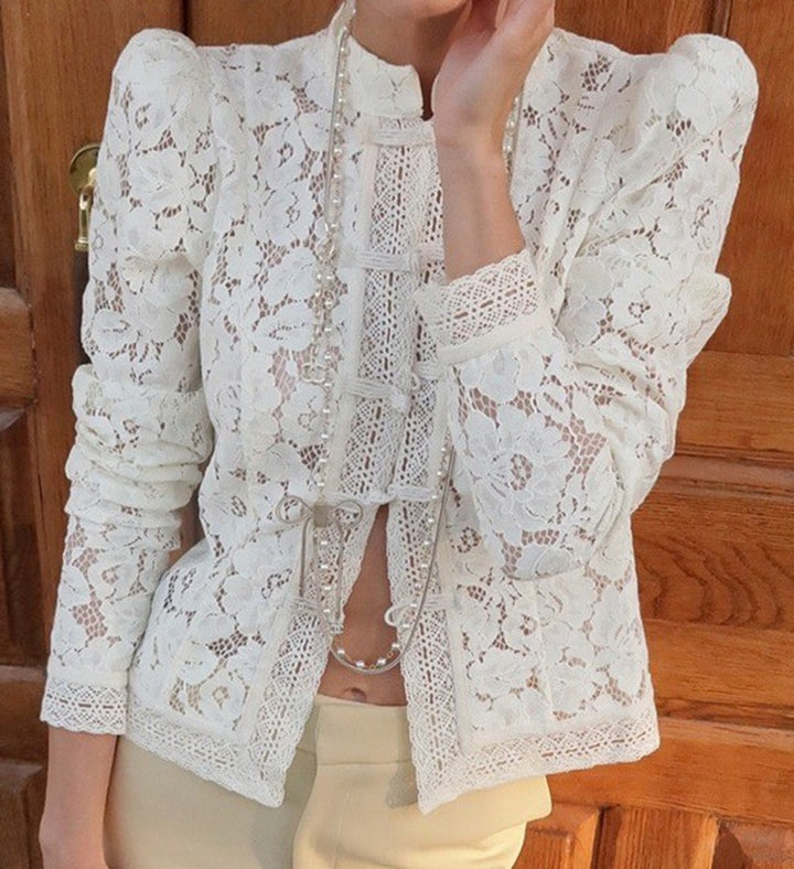Women's figure-hugging lace blouse with stand collar, decorative knot closure, and crocheted hem StylebySassy