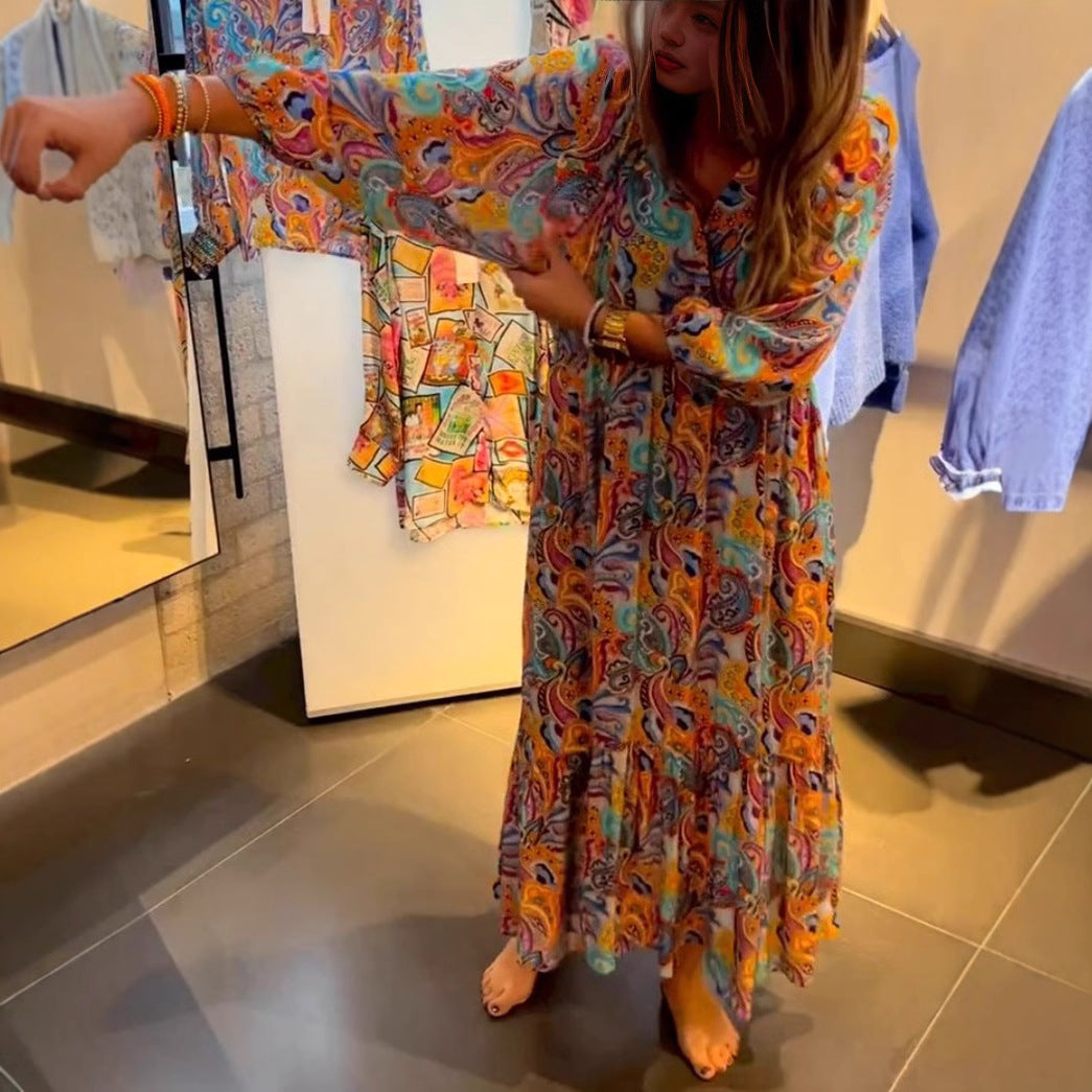 Women's tiered maxi dress in boho style with paisley print, V-neck, gathered empire waist and elastic cuffs StylebySassy