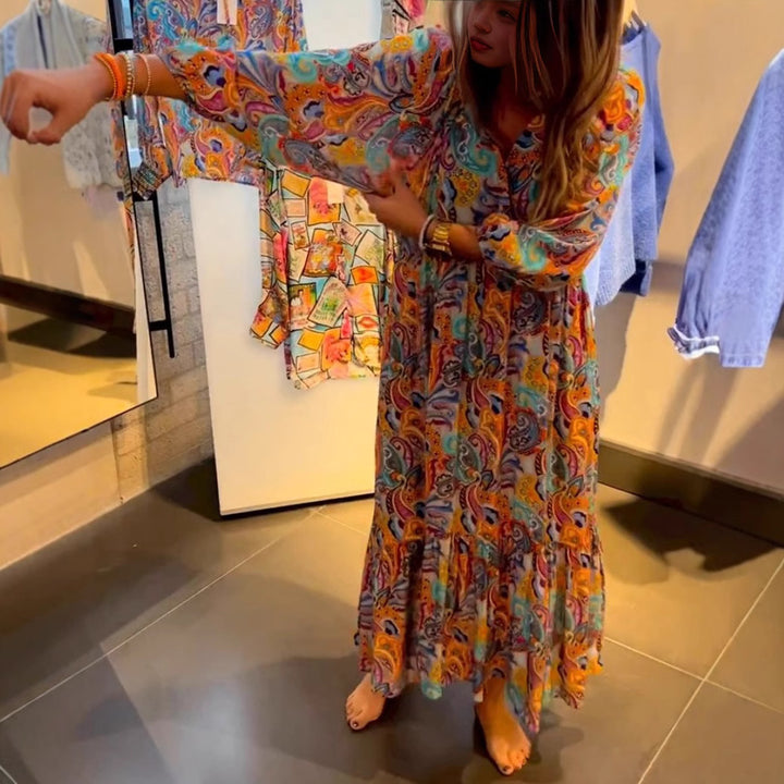 Women's tiered maxi dress in boho style with paisley print, V-neck, gathered empire waist and elastic cuffs StylebySassy