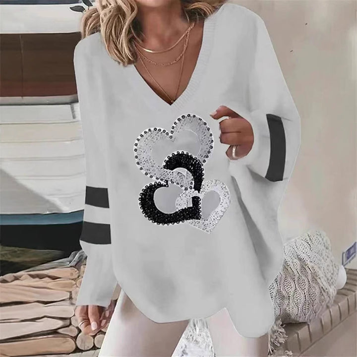 Women's oversized knitted sweater with deep neckline sequin heart and contrast sleeve stripes StylebySassy