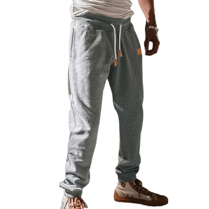 Men's tapered leisure pants made of sweat fabric with elastic waistband, drawstring, and ribbed cuffs StylebySassy