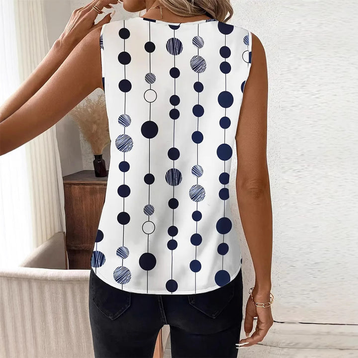 Women's V-neck blouse top with vertical polka dot pattern and subtle center seam StylebySassy