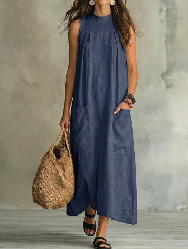 Women’s sleeveless linen maxi dress with standing collar, pleats at the chest, and piled pockets StylebySassy