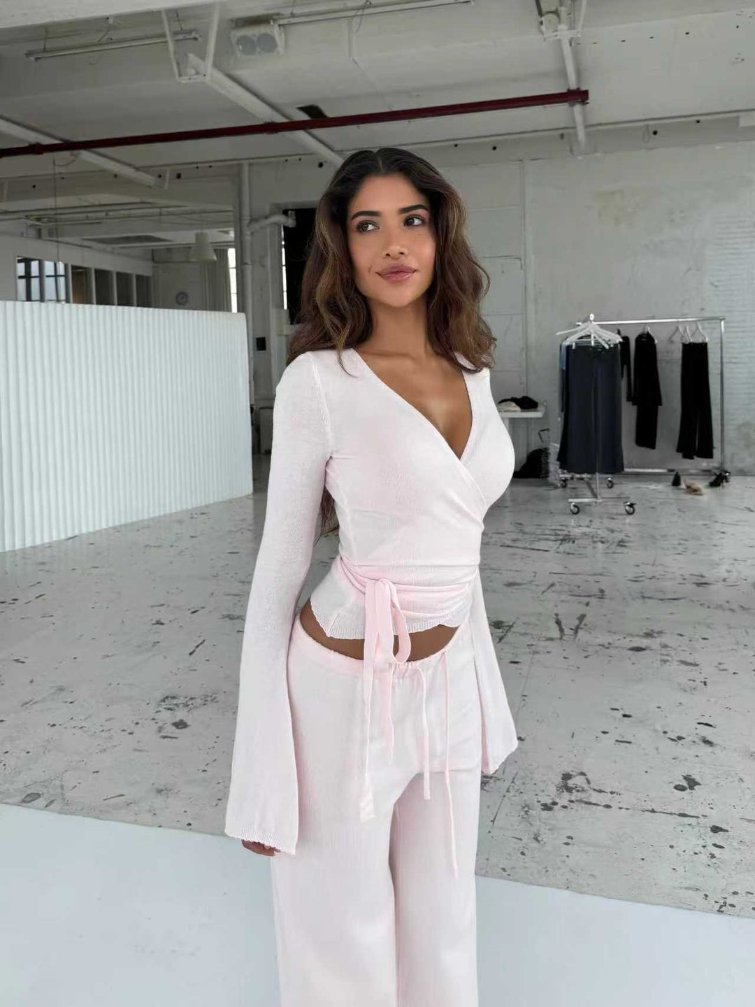 Women's knitted wrap top with tie belt and trumpet sleeves, as well as high-waisted wide-cut knitted pants StylebySassy