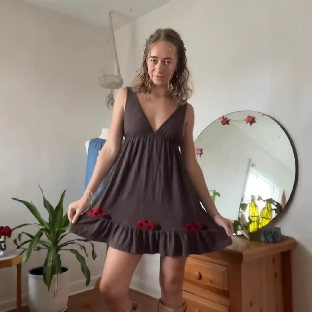 Women's sleeveless mini dress with deep V-neck underbust seam and ruffle hem with ladybug appliqué StylebySassy