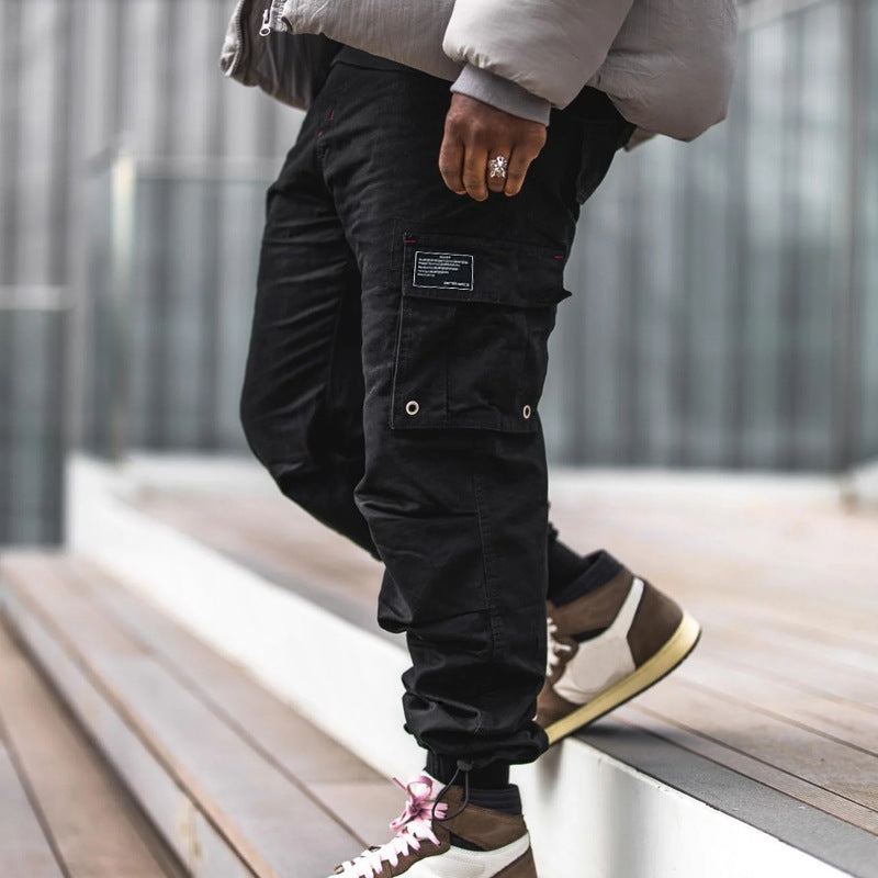 Men's multi-pocket casual trousers made of cotton twill with tapered leg and adjustable ankle drawstring StylebySassy