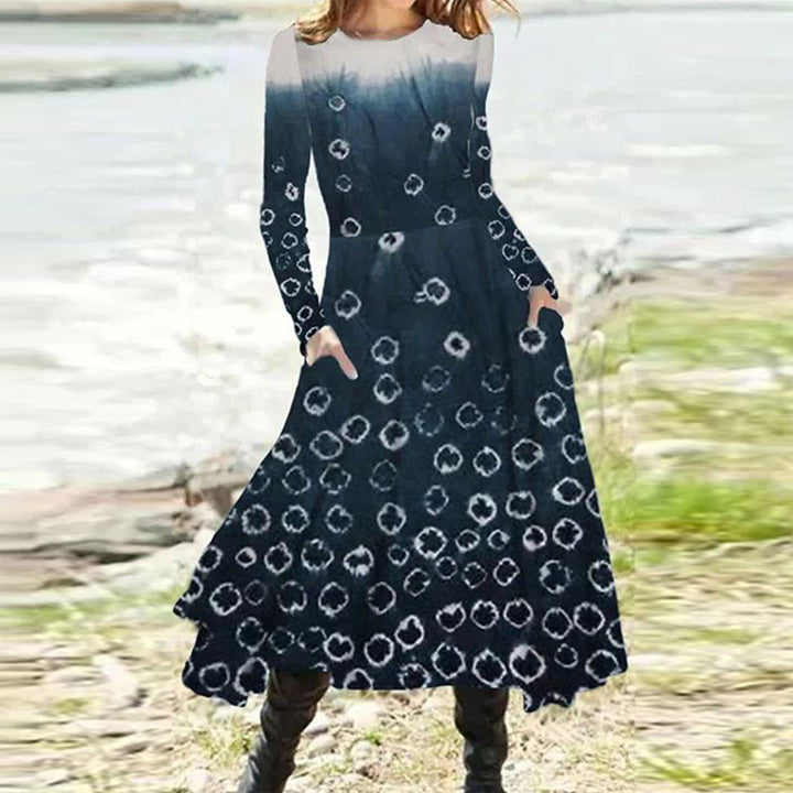 Women's flowing maxi dress with tie-dye circle pattern, round neckline, waist seam, and side pockets StylebySassy