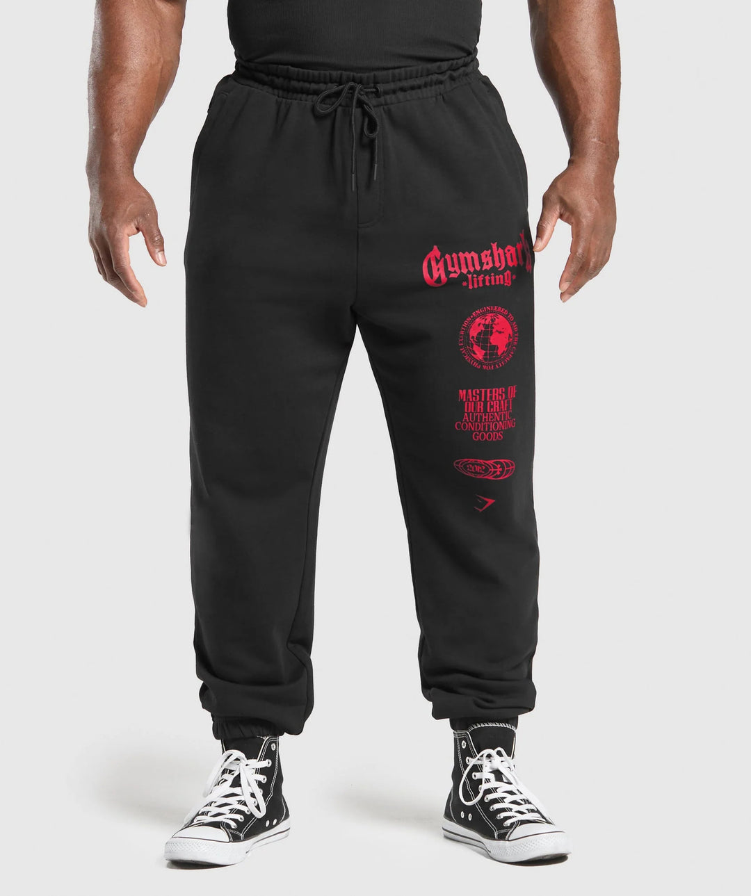 Men's tapered cotton fleece sweatpants with an elastic drawstring waistband, ribbed leg openings, and large logo print StylebySassy