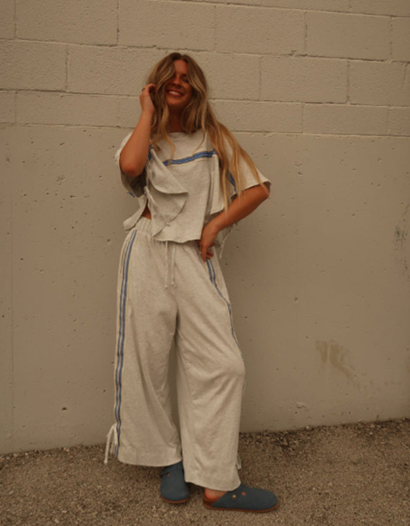 Ladies two-piece leisure ensemble with boxy ruffle top and wide cord pants with side decorative stripe StylebySassy