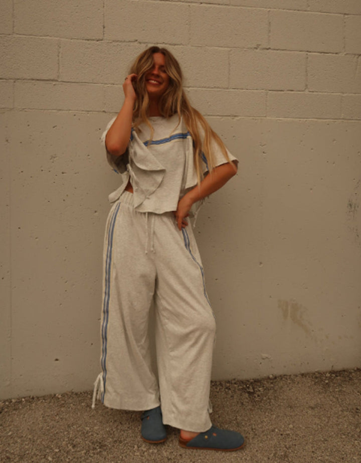 Ladies two-piece leisure ensemble with boxy ruffle top and wide cord pants with side decorative stripe StylebySassy