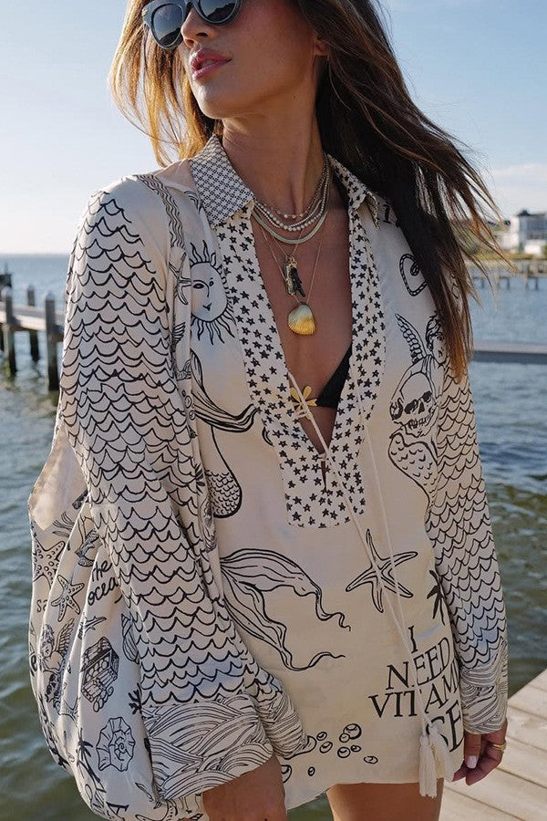 Ladies lightweight beach cover-up in tunic form with deep V-neck, tassel closure, and nautical ocean print StylebySassy