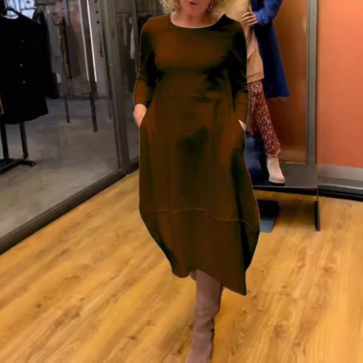 Women's asymmetrical balloon dress with three-quarter sleeves, side pockets, and flowing pointed hem StylebySassy